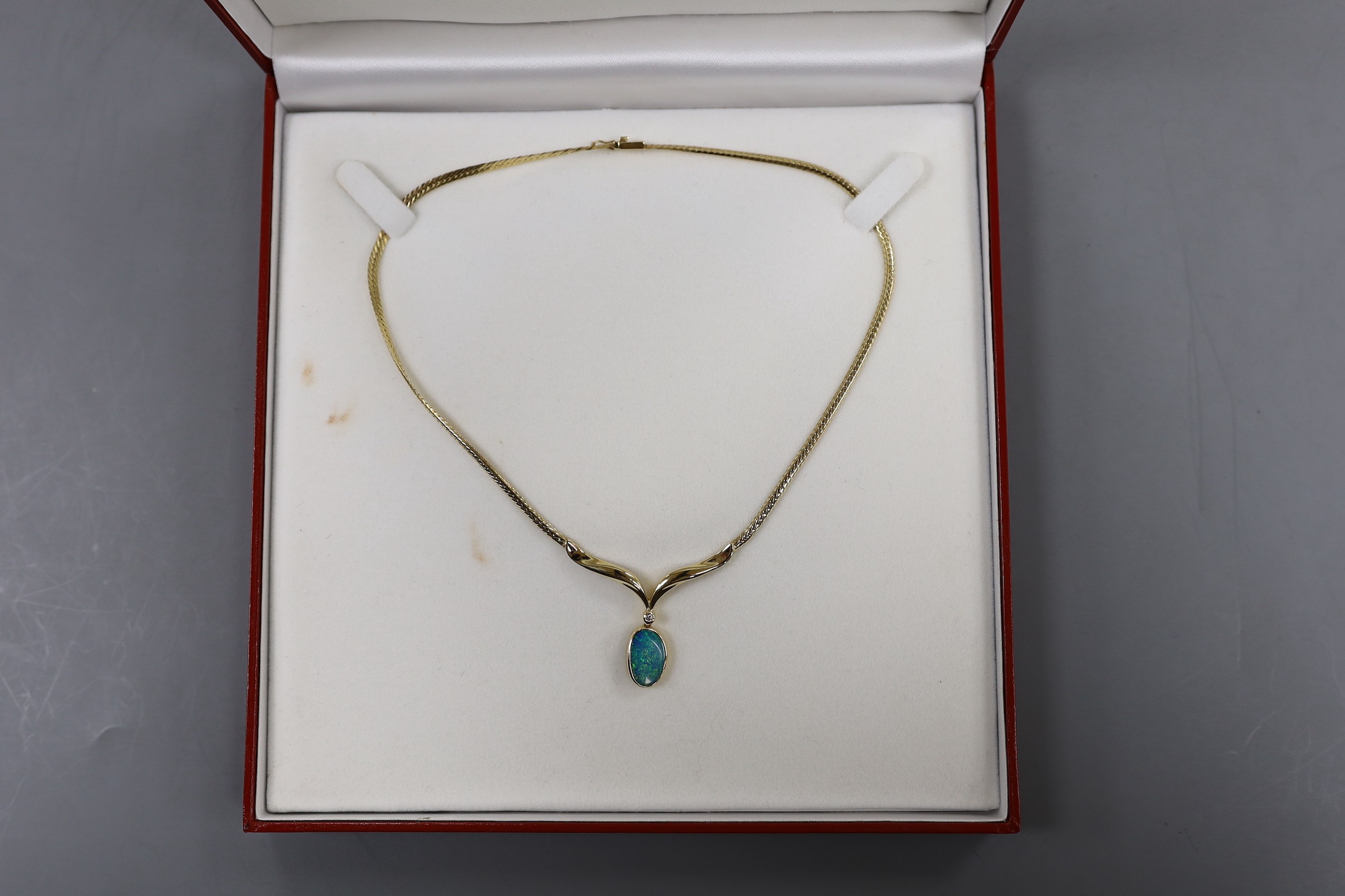 A modern 585 yellow metal and black opal doublet? and diamond set drop pendant necklace, overall 37cm, gross weight 12.5 grams.